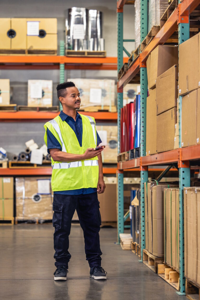 Man in a warehouse holding a Honeywell CT70